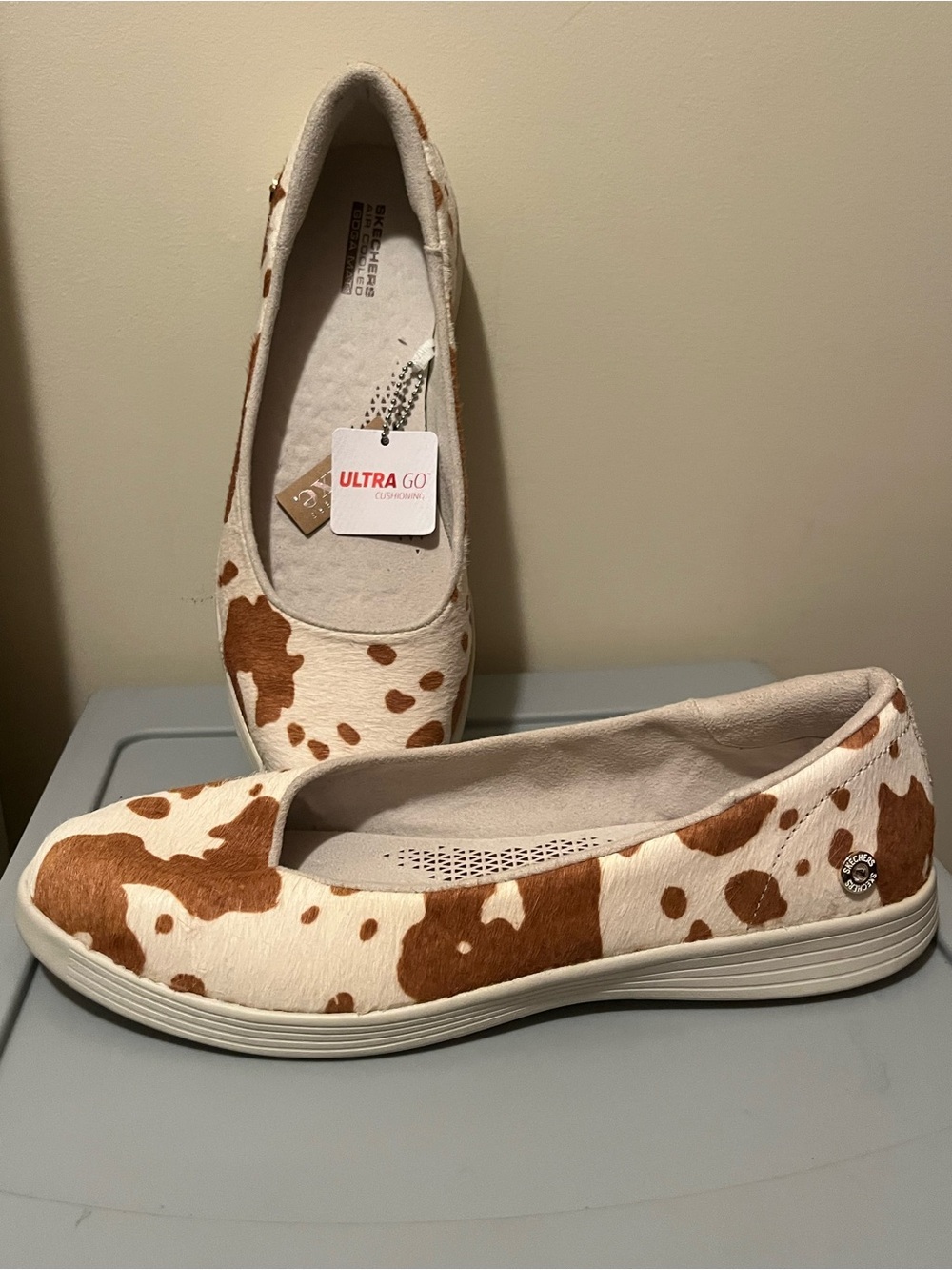 Skechers Ultra GO Cow-Pattern Slip-On Flats in White and Brown Haircalf
